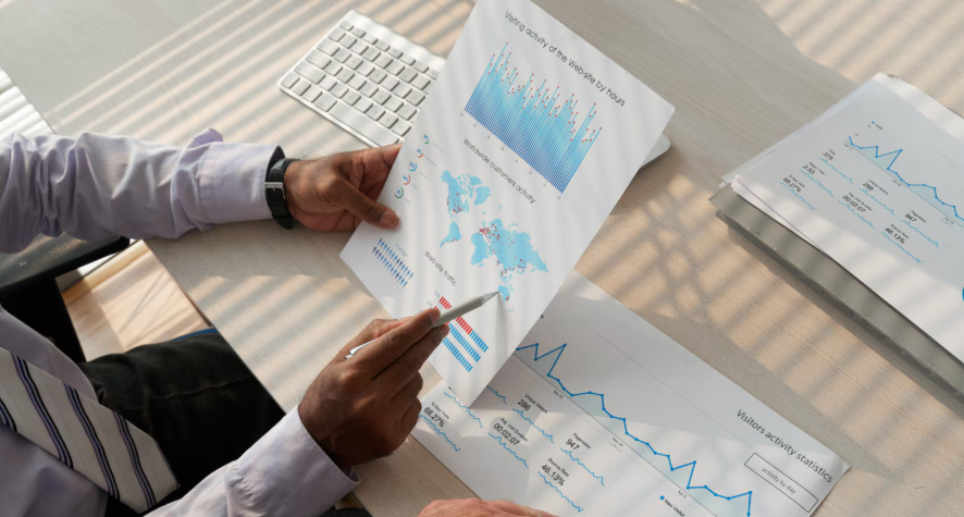 Researcher comparing printed charts and data reports