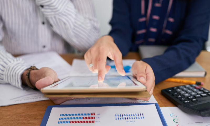Colleagues reviewing data together on a tablet